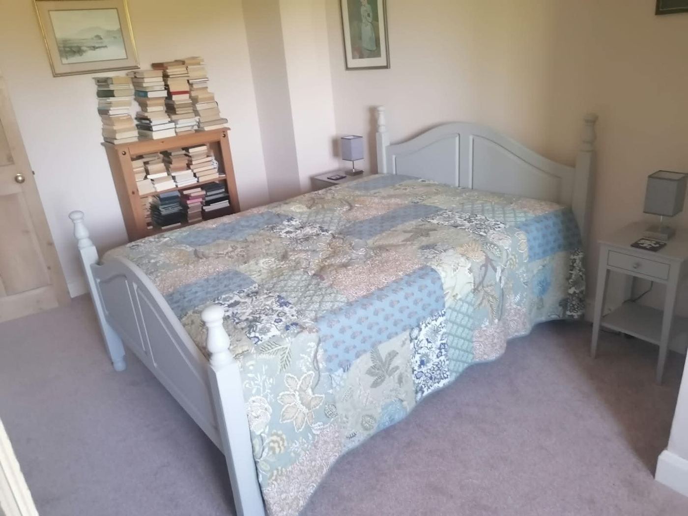 Restored pine bed frame, painted pale grey and styled in bedroom